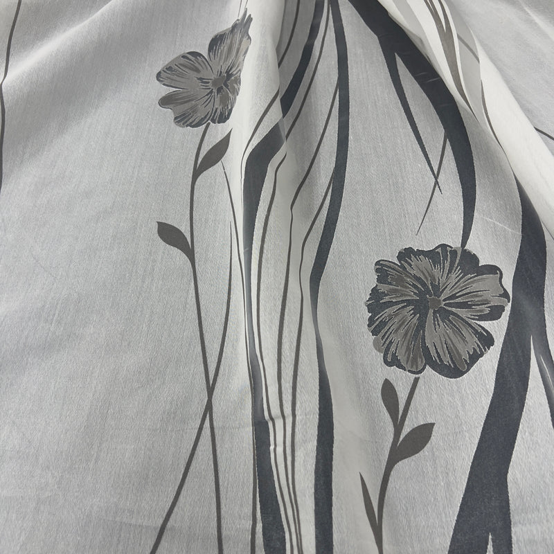 Tenda in poliestere devoré fantasia fiori e steli, altezza 300 cm, orlo piombato, disponibile in due varianti colore.